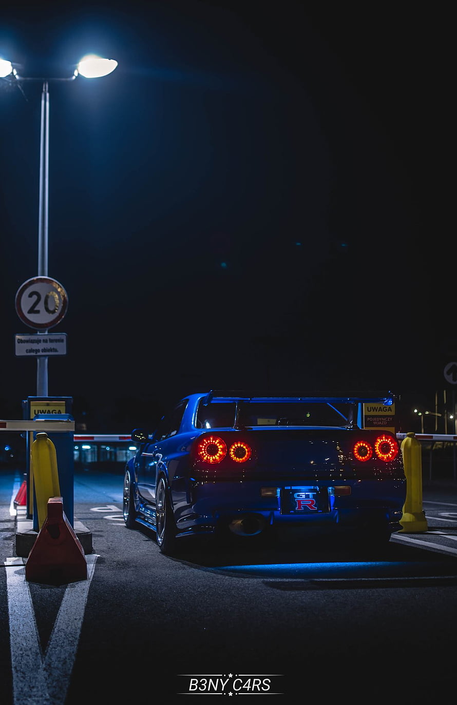 Nissan R34 GT-R V-Spec Rear View at Night with Blue Underglow and LED Taillights HD phone wallpaper