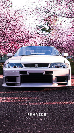White Nissan Skyline R33 GT-R Front View Under Cherry Blossom Trees HD phone wallpaper