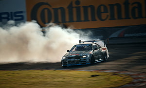 Nissan Skyline R34 GTR Drifting on Race Track with Tire Smoke HD wallpaper