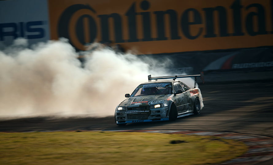 Nissan Skyline R34 GTR Drifting on Race Track with Tire Smoke HD wallpaper