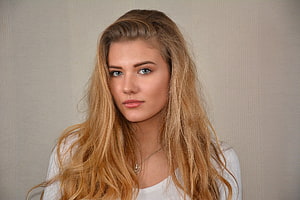 Portrait of a young woman with long wavy blonde hair and blue eyes wearing a white top, Unknown Model, babe, lady, model, blonde, woman HD wallpaper