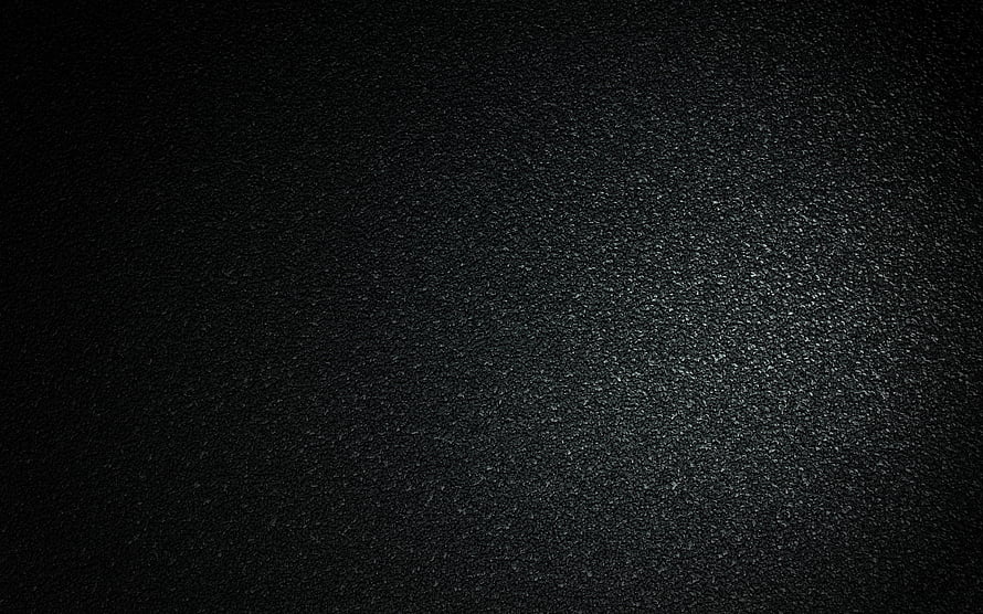 Dark Asphalt Surface Texture with Subtle Stone Grain and Vignette Lighting HD wallpaper