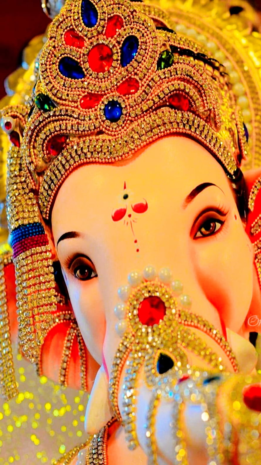 Ganesha ornate jeweled crown and gemstone adorned face close-up portrait HD phone wallpaper