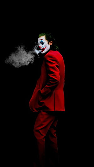 Joker in Red Suit Smoking Cigarette Against Dark Background HD phone wallpaper