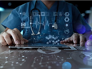 Doctor in Blue Scrubs Using Tablet with Medical Data and Stethoscope HD wallpaper