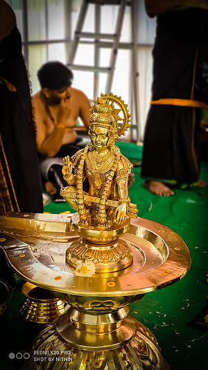 Golden Ayyappa Murti on Brass Pedestal During Temple Ritual HD phone wallpaper