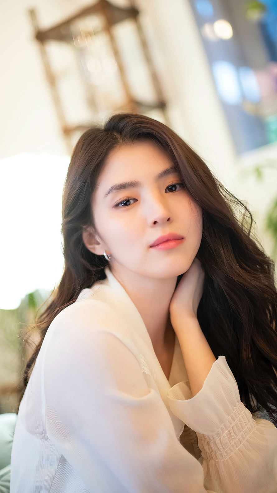 Han So Hee in a White Blouse with Soft Natural Light and Long Wavy Hair HD phone wallpaper