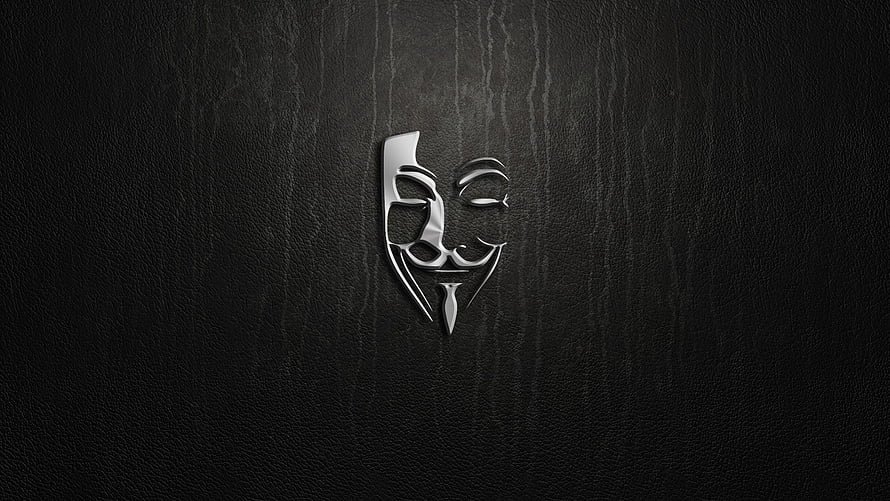 Sleek Silver Anonymous Guy Fawkes Mask Emblem on Dark Textured Background HD wallpaper