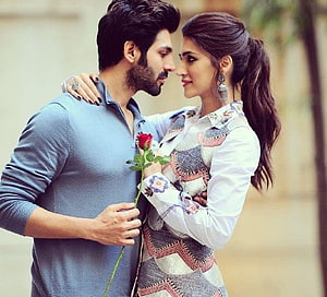Romantic Bollywood Couple Sharing a Tender Moment with a Red Rose HD wallpaper