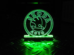 Glowing Green Skoda Auto Neon Sign on Textured Metal Surface HD wallpaper