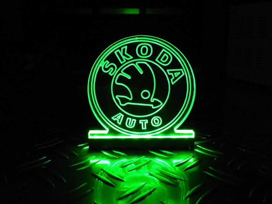 Glowing Green Skoda Auto Neon Sign on Textured Metal Surface HD wallpaper