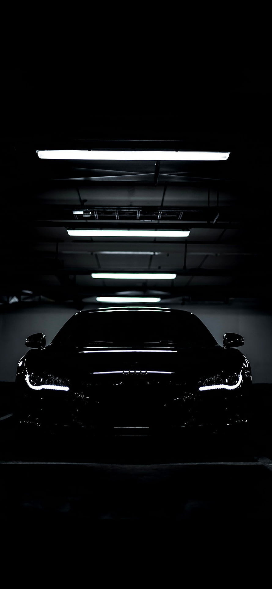 Black Audi R8 Front View in Dark Parking Garage with LED Headlights and Fluorescent Ceiling Lights HD phone wallpaper