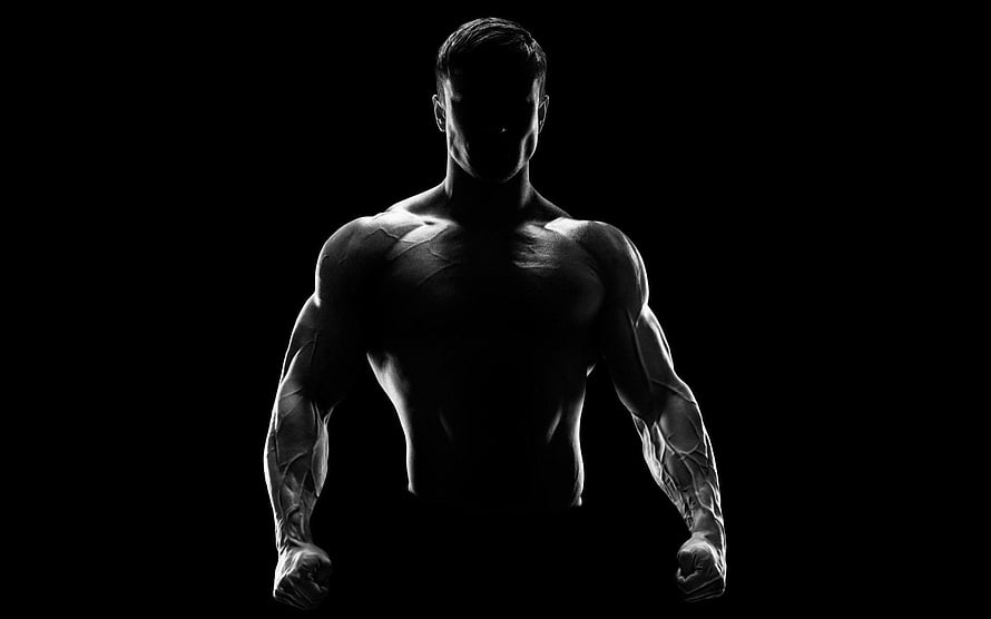 Dramatic Black and White Silhouette of a Muscular Male Athlete with Defined Physique HD wallpaper