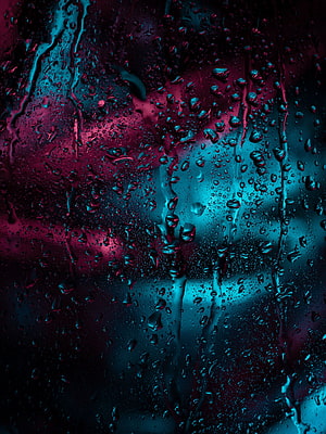 Moody Macro Shot of Rain Droplets on Glass with Neon Cyan and Magenta Lighting HD phone wallpaper