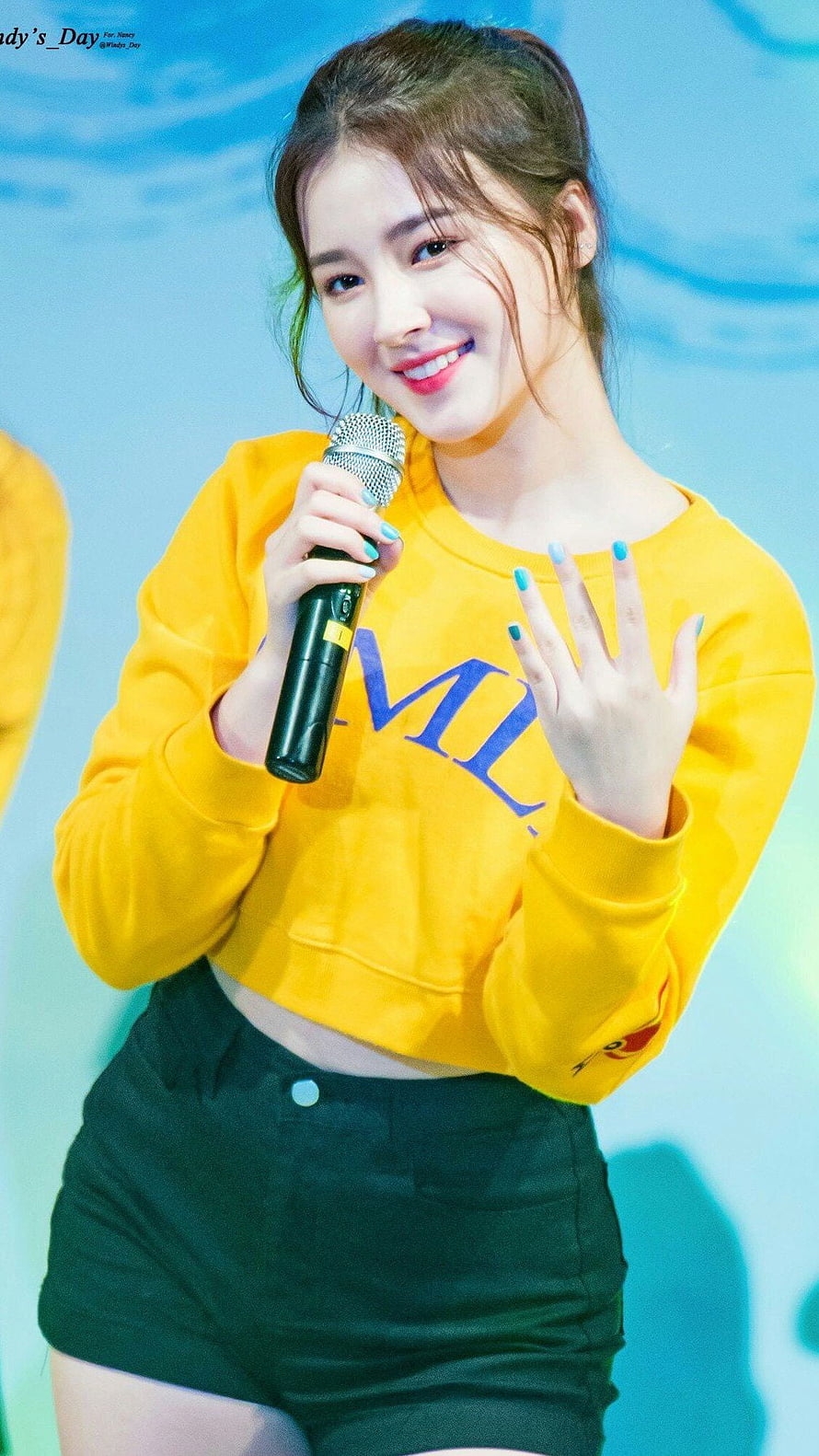 Nancy from Momoland performing on stage in a yellow cropped sweatshirt and black shorts HD phone wallpaper