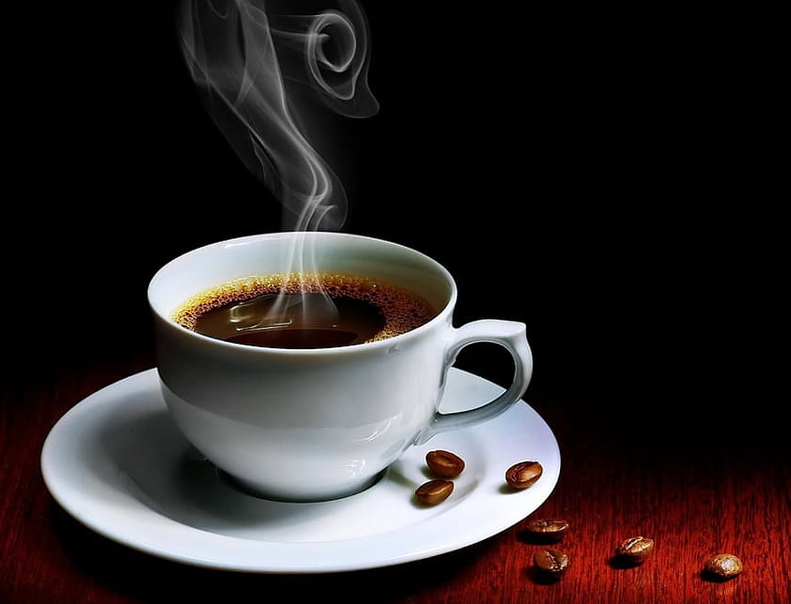 Steaming White Coffee Cup on Saucer with Scattered Beans Against Dark Background HD wallpaper