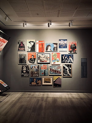 Vintage Propaganda Poster Collection Displayed in a Modern Art Gallery HD phone wallpaper