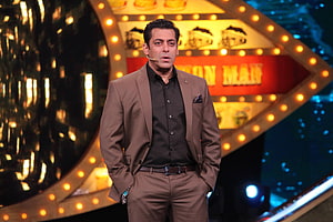 Salman Khan in Brown Suit on Bigg Boss Stage with Marquee Lights HD wallpaper
