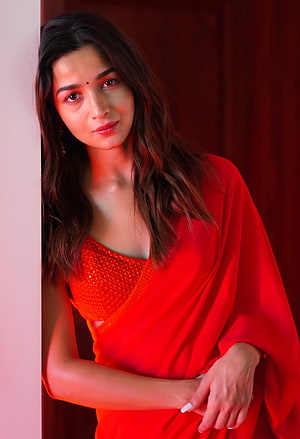 Alia Bhatt in a vibrant red sequined outfit with warm cinematic lighting HD phone wallpaper
