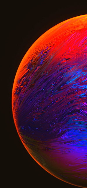 Vibrant Swirling Liquid Sphere with Neon Red and Blue Abstract Patterns on Black Background HD phone wallpaper