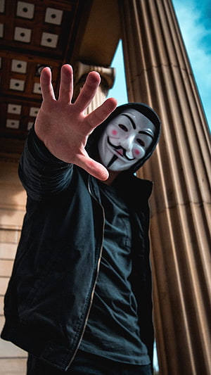 Person Wearing Guy Fawkes Mask Reaching Forward Near Classical Column HD phone wallpaper