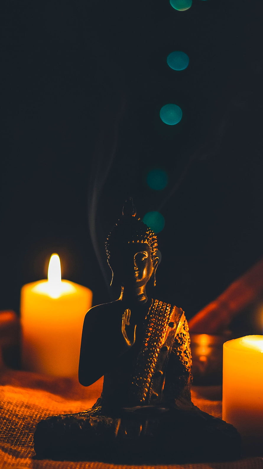 Lord Buddha Statue Illuminated by Warm Candlelight in a Serene Meditation Setting HD phone wallpaper