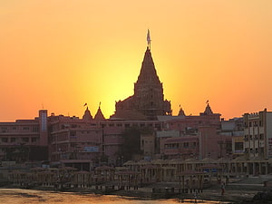 Dwarkadhish Temple Silhouette Against Golden Sunset Sky in Puri HD wallpaper