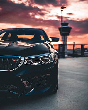 Black BMW M5 F90 Front Grille and Headlights at Sunset HD phone wallpaper