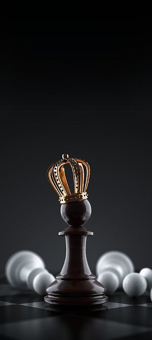 Dark wooden chess king crowned in gold standing on a checkered board with fallen white pieces HD phone wallpaper