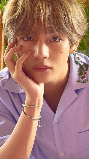 V from BTS in a lavender embroidered shirt with delicate silver bracelets and soft natural lighting HD phone wallpaper