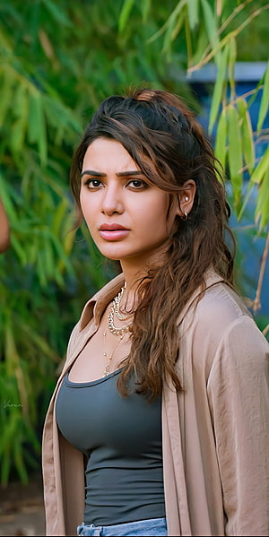 Samantha Prabhu in a beige jacket and dark top with layered gold jewelry against a green bamboo backdrop HD phone wallpaper
