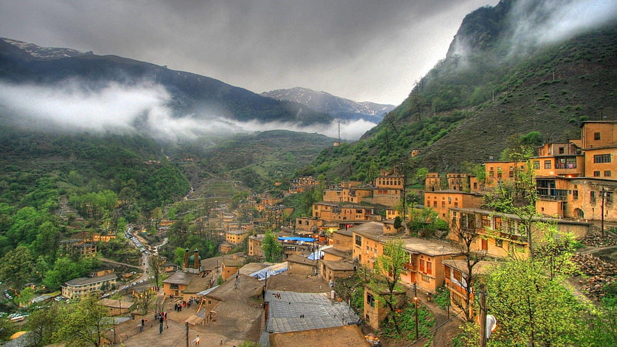 Misty Mountain Village in Iran with Terracotta Buildings and Lush Green Hills HD wallpaper