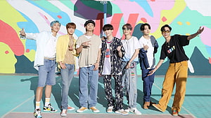 BTS Members Posing on Colorful Basketball Court with Vibrant Mural Background HD wallpaper