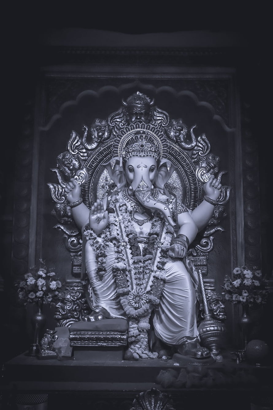 Ganesha Temple Idol in Black and White with Floral Garland and Ornate Carvings HD phone wallpaper