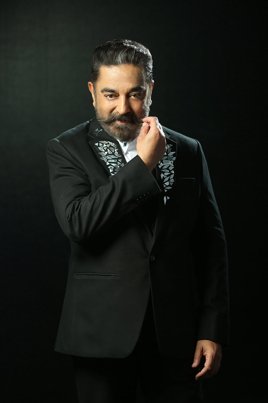 Kamal Haasan in a black tuxedo with geometric lapel details against a dark studio backdrop HD phone wallpaper