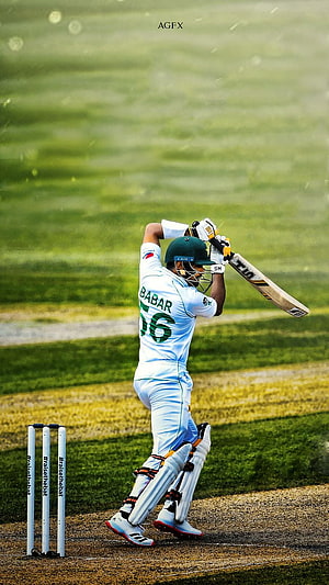 Babar Azam in Pakistan whites executing a powerful cricket batting stroke on the field HD phone wallpaper