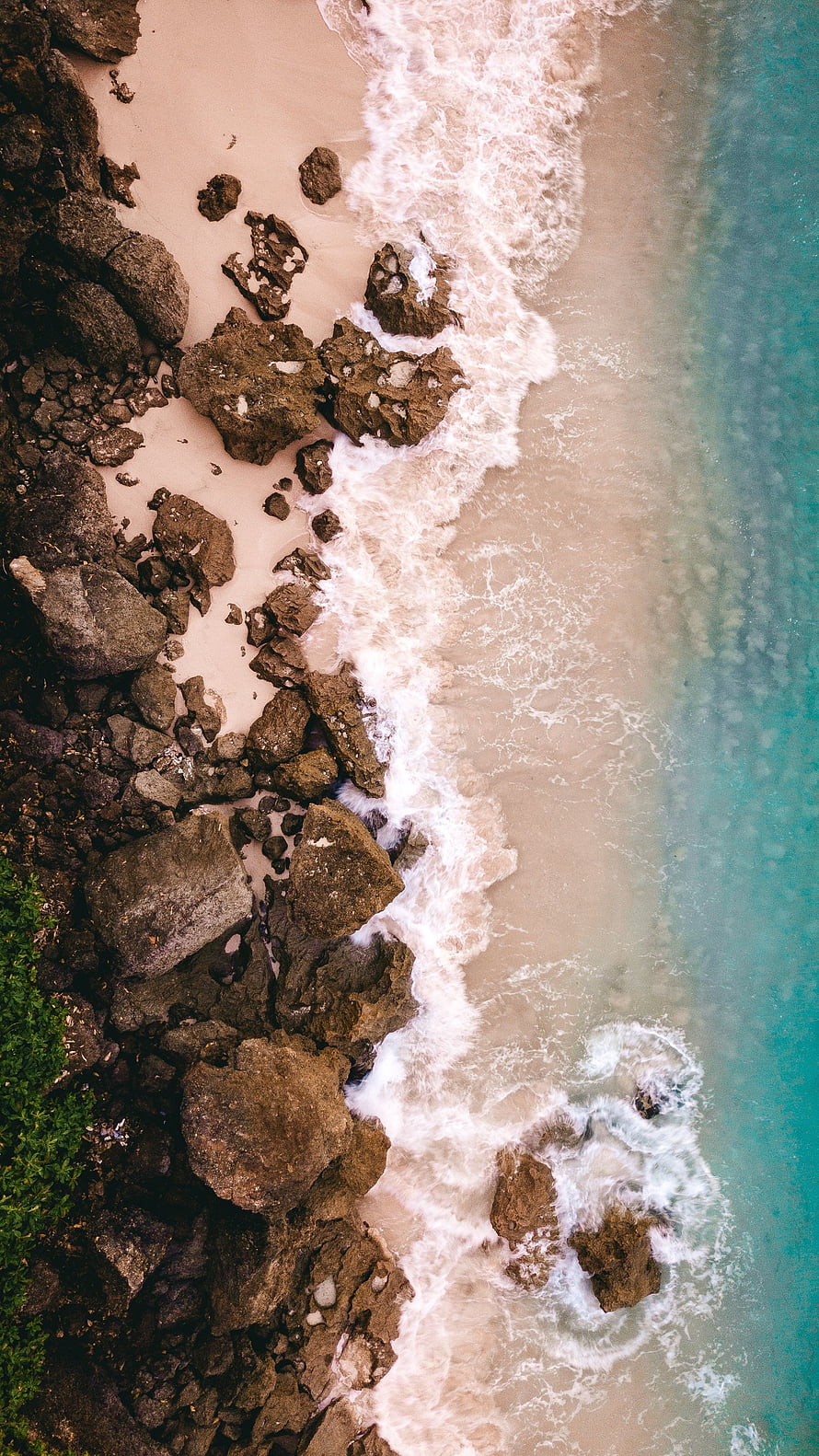 Aerial View of Rocky Shoreline with Turquoise Sea Waves and White Foam HD phone wallpaper