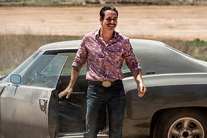Lalo Salamanca standing beside a classic car in a dusty field from Better Call Saul HD wallpaper