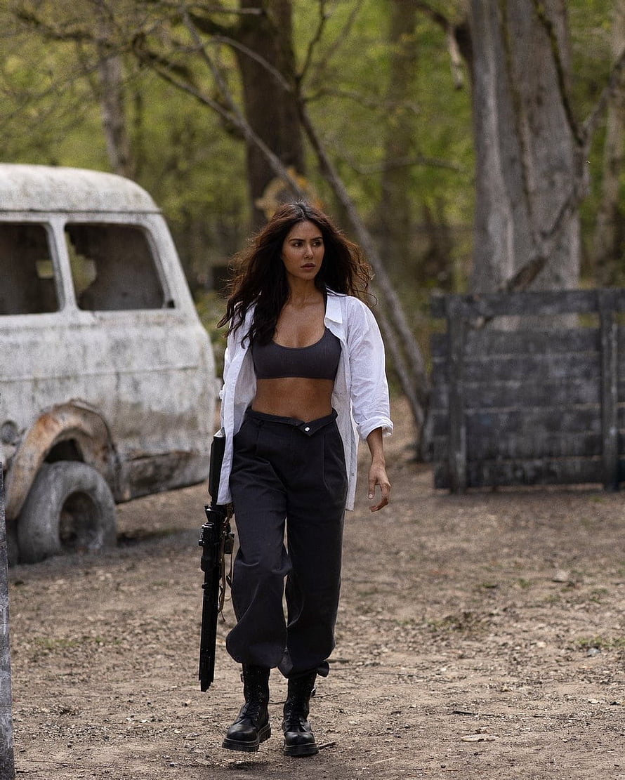 Sonam Bajwa in Action Scene with Rifle and Rusted Van in Forest HD phone wallpaper