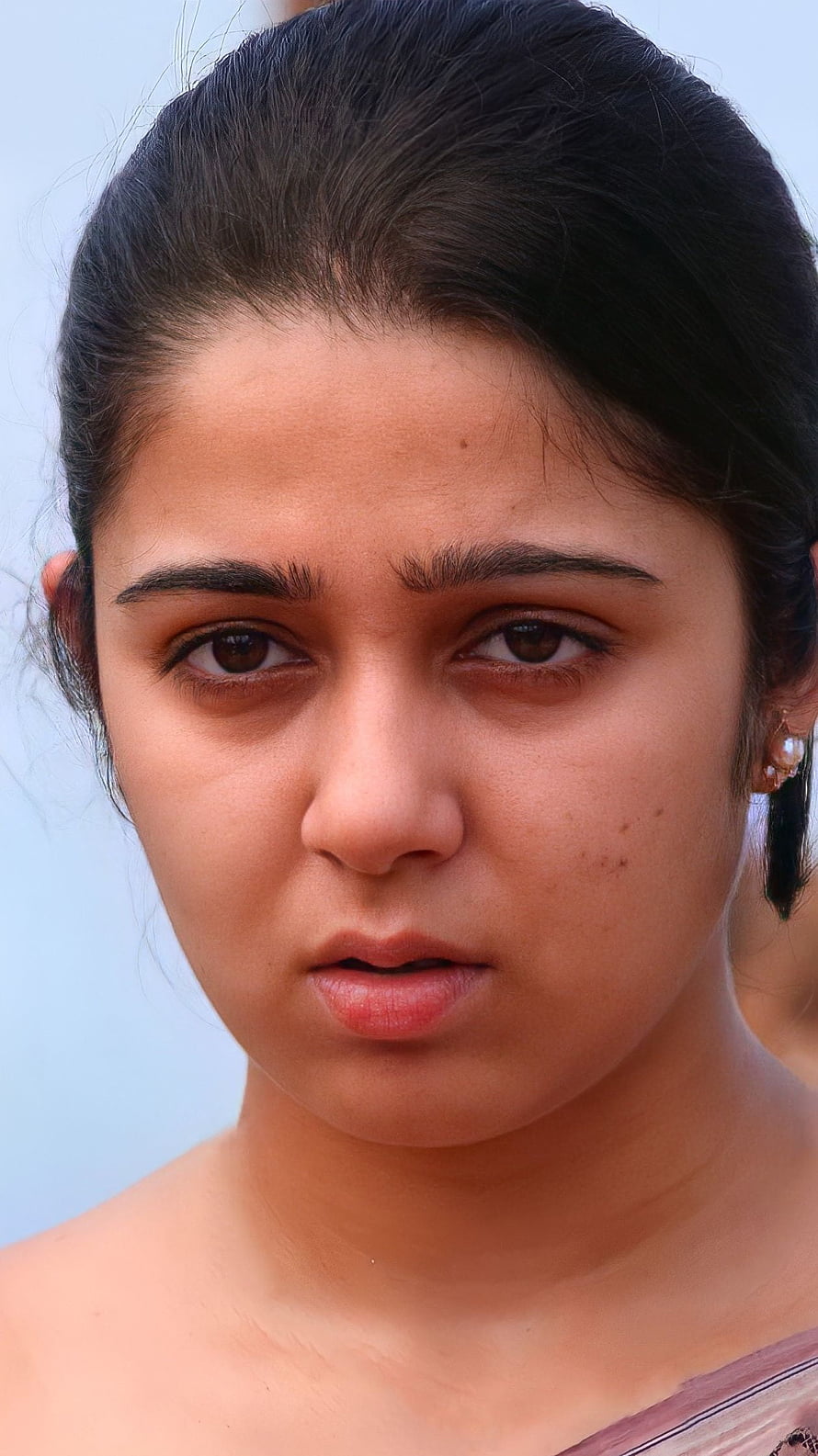 Charmi Kaur Portrait: Close-Up of Telugu Actress with Dark Hair and Pearl Earring HD phone wallpaper
