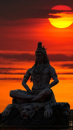 Lord Shiva Statue Silhouette Against Vibrant Orange Sunset Sky HD phone wallpaper