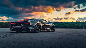 Bugatti Chiron Super Sport 300 Prototype on an open tarmac under a dramatic sunset sky HD wallpaper