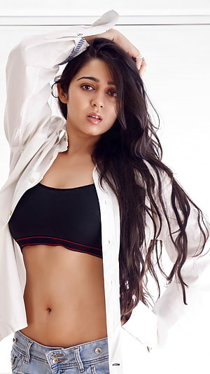 Charmi Kaur in a White Shirt and Black Sports Bra with Denim Jeans HD phone wallpaper