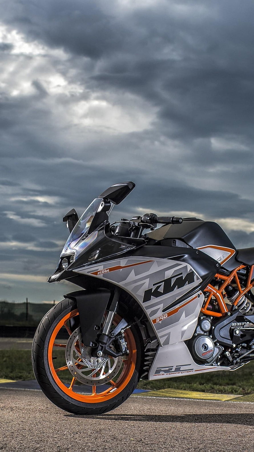 KTM RC 390 Race Competition Motorcycle on Track Under Stormy Sky HD phone wallpaper
