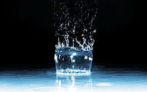 Dramatic Water Splash and Spray Captured in a Dark Studio Setting HD wallpaper
