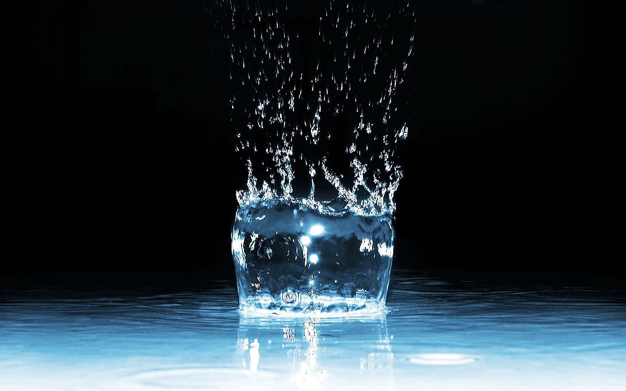 Dramatic Water Splash and Spray Captured in a Dark Studio Setting HD wallpaper