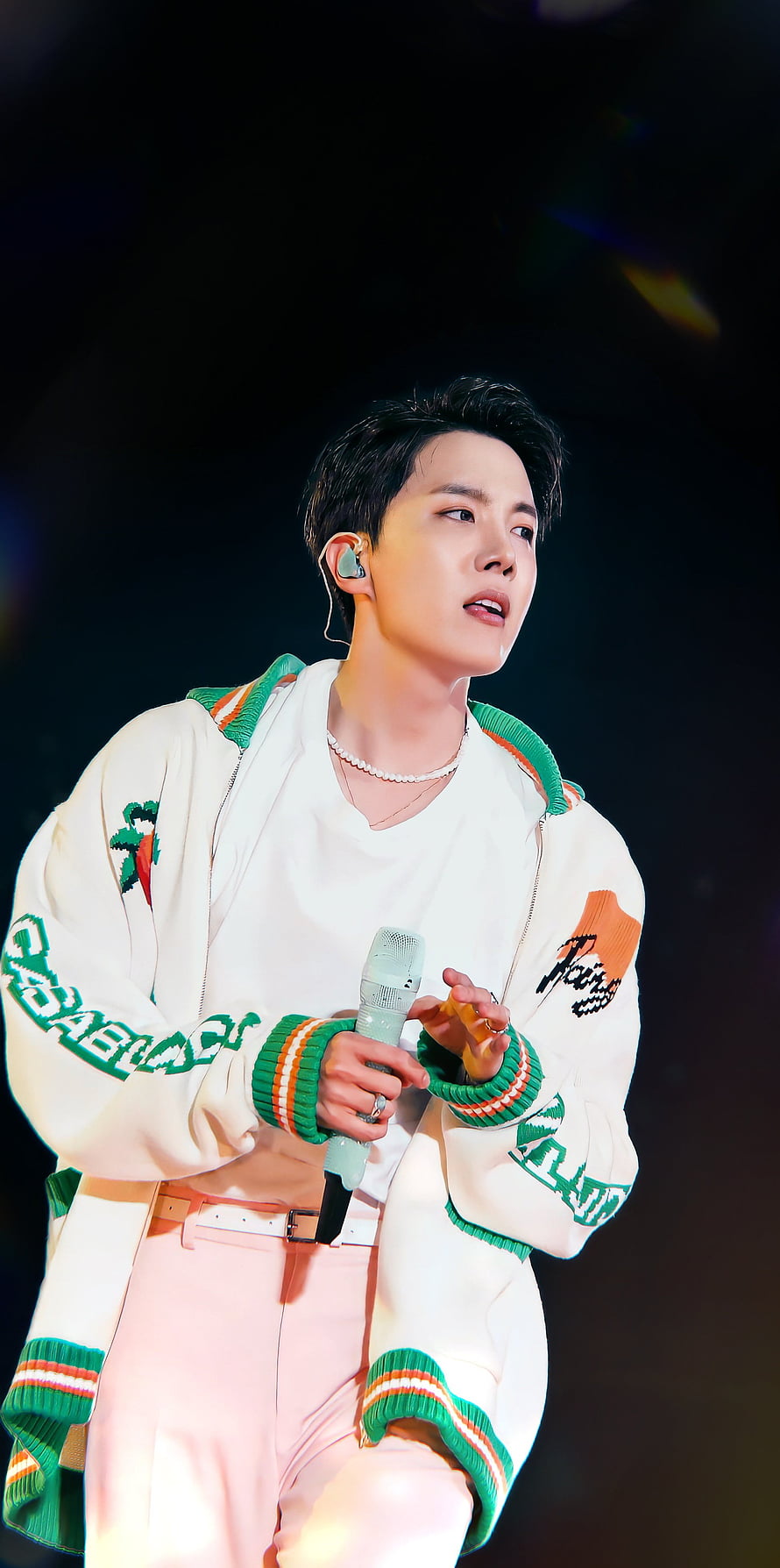 J-Hope from BTS performing on stage in a white and green jacket with microphone HD phone wallpaper