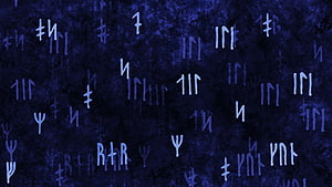 Ancient Norse Rune Carvings on Dark Textured Stone Surface HD wallpaper