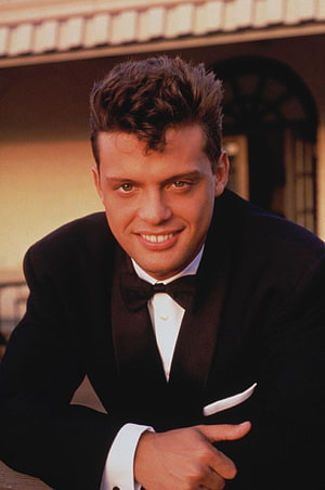 Luis Miguel in a classic black tuxedo with bow tie and white pocket square HD phone wallpaper