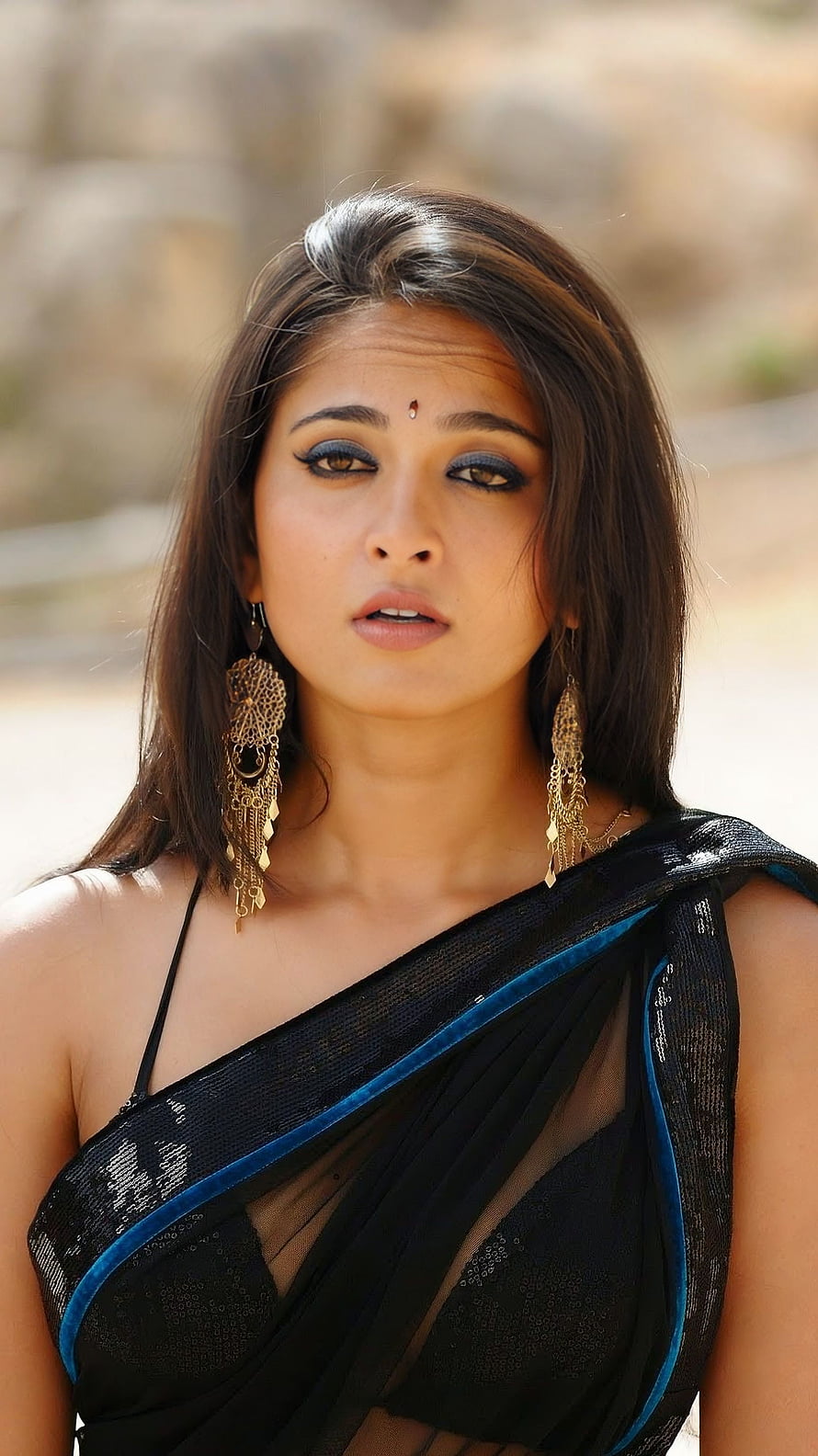 Anushka Shetty in a Black Saree with Blue Border and Gold Jhumka Earrings HD phone wallpaper